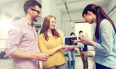 Image showing creative team with tablet pc talking at office