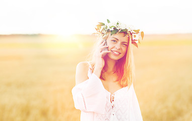 Image showing happy young woman calling on smartphone at country