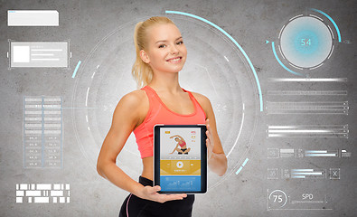 Image showing sporty woman with fitness application on tablet pc
