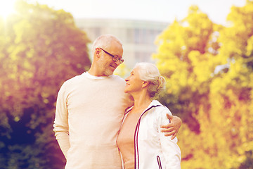 Image showing senior couple hugging in city park