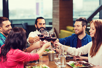 Image showing friends dining and drinking wine at restaurant