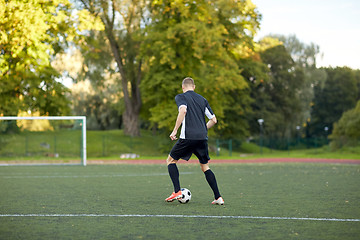 Image showing soccer player playing with ball on football field