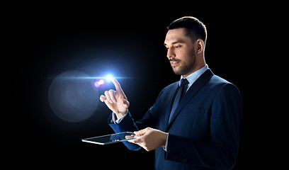 Image showing businessman in suit with transparent tablet pc