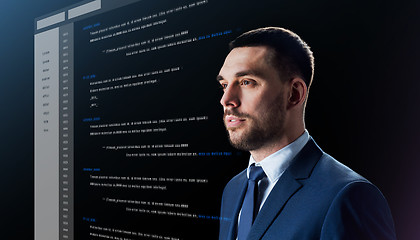 Image showing businessman with coding on virtual screen