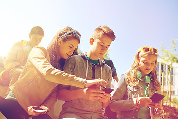 Image showing teenage friends with smartphone and headphones