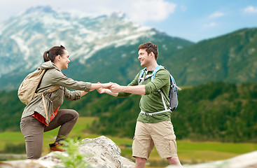 Image showing happy couple with backpacks traveling in highlands