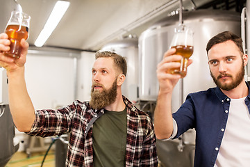 Image showing men drinking and testing craft beer at brewery