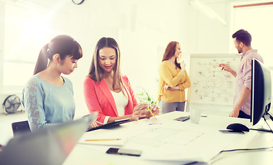 Image showing happy creative team with tablet pc at office