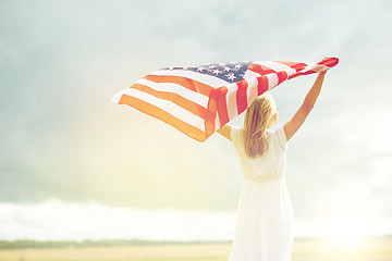 Image showing happy woman with american flag on cereal field