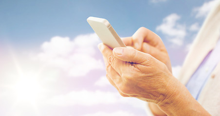 Image showing close up of senior woman with smartphone texting
