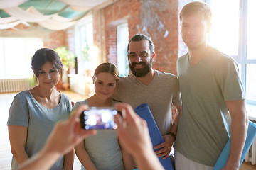 Image showing happy people at yoga studio or gym photographing