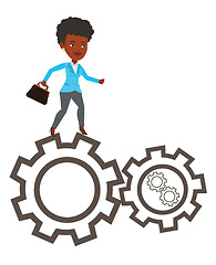 Image showing Business woman running on cogwheels.