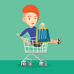 Image showing Happy woman riding by shopping trolley.
