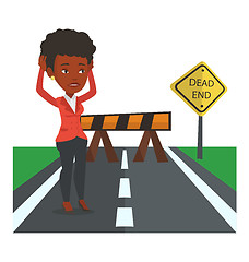 Image showing Business woman looking at road sign dead end.