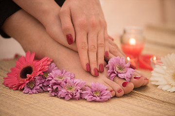 Image showing female feet and hands at spa salon