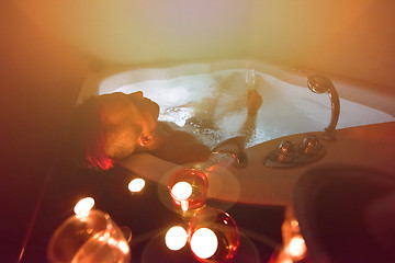 Image showing man relaxing in the jacuzzi