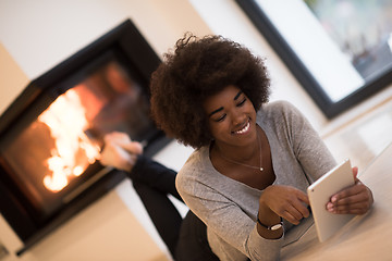 Image showing black women using tablet computer on the floor