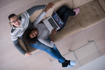 Image showing happy multiethnic couple relaxes in the living room