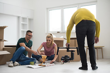 Image showing young couple have a pizza lunch break on the floor