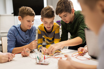 Image showing happy kids with invention kit at robotics school