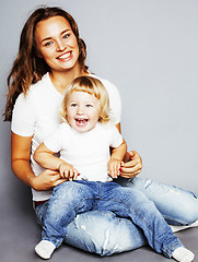 Image showing young pretty stylish mother with little cute blond daughter hugg