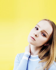 Image showing lifestyle people concept: pretty young school teenage girl having fun happy smiling on yellow background