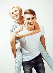 Image showing young pretty teenage couple, hipster guy with his girlfriend happy smiling and hugging isolated on white background, lifestyle people concept