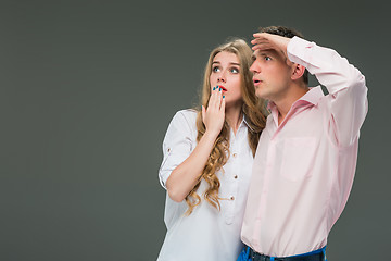 Image showing Portrait of a young couple standing against gray background