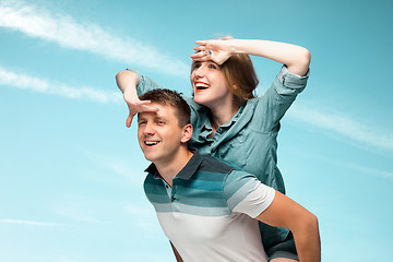 Image showing Young couple smiling under blue sky