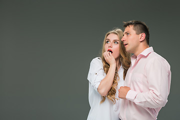 Image showing Portrait of a young couple standing against gray background