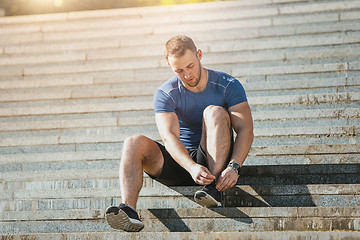 Image showing Fit man doing exercises outdoors at park