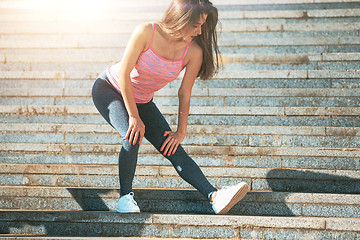 Image showing Fit fitness woman doing stretching exercises outdoors at park