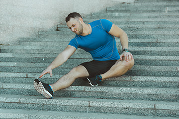 Image showing Fit man doing exercises outdoors at park