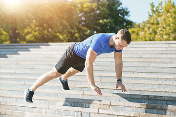 Image showing Fit man doing exercises outdoors at park