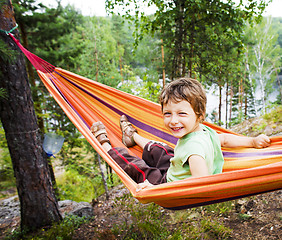 Image showing little cute boy in hammock smiling