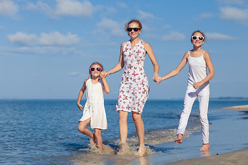 Image showing Mother and children playing on the beach at the day time.