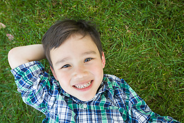 Image showing Mixed Race Chinese and Caucasian Young Boy Relaxing On His Back 