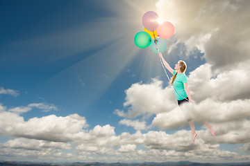 Image showing Young Adult Female Being Carried Up and Away Into The Clouds By 