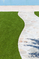 Image showing New Artificial Grass Installed Near Walkway and Pool.