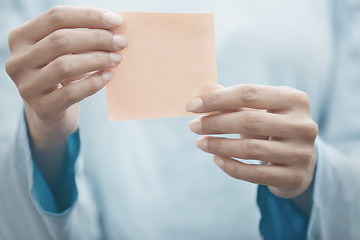 Image showing Yoga instructor holding adhesive note