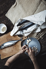 Image showing Woman preparing fish