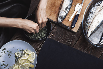 Image showing Woman preparing marinade for fish