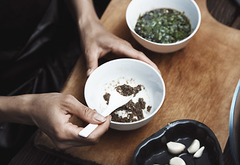 Image showing Woman preparing Indian sauce for vegetarian food