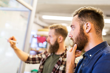 Image showing men writing to whiteboard at office