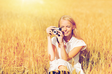 Image showing happy woman with film camera in wreath of flowers