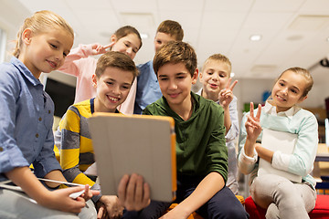 Image showing group of happy children with tablet pc at school