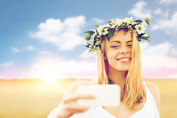 Image showing happy young woman taking selfie by smartphone