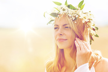 Image showing happy woman in wreath of flowers