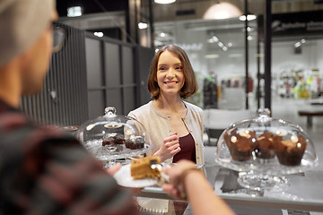 Image showing man or barman with cake serving customer at cafe