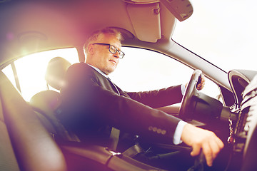 Image showing happy senior businessman driving car